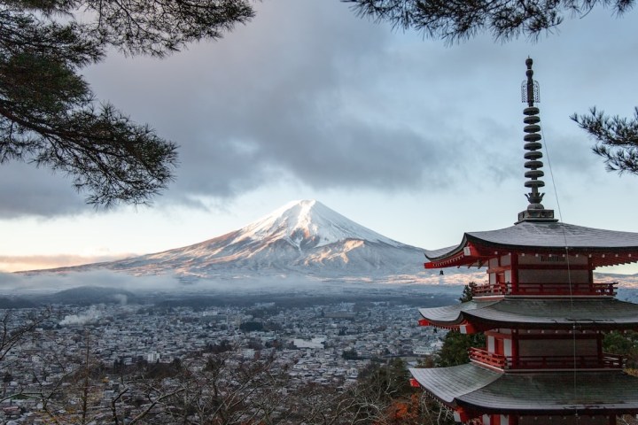 a large body of water with Mount Fuji in the background