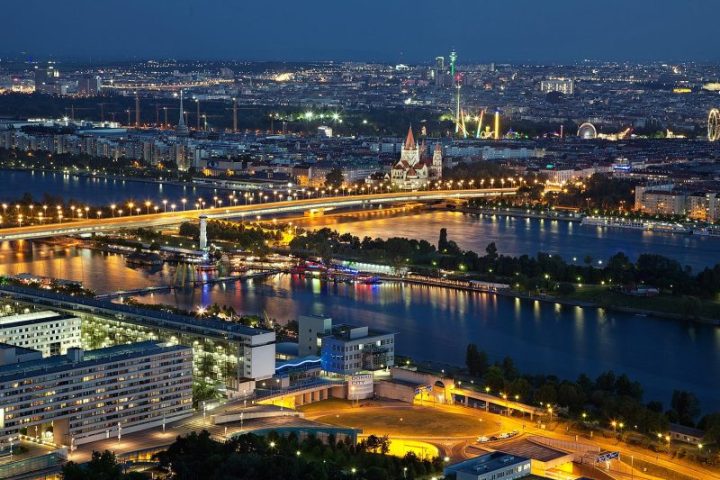 a large body of water with a city in the background