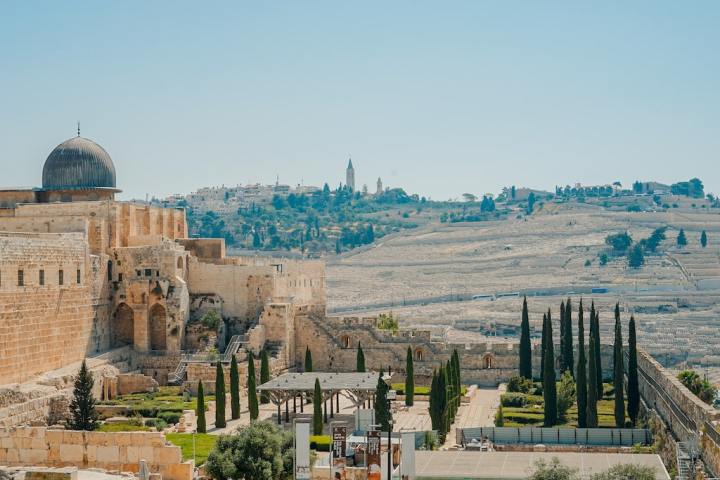 a large building with a mountain in the background
