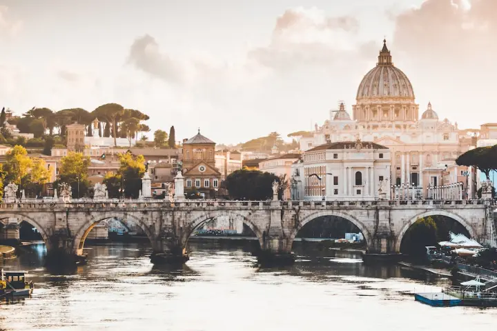 a bridge over water with a city in the background