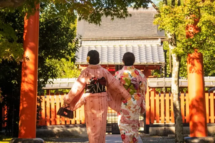 a man standing in front of a fence