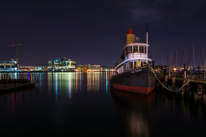 a boat is docked next to a body of water